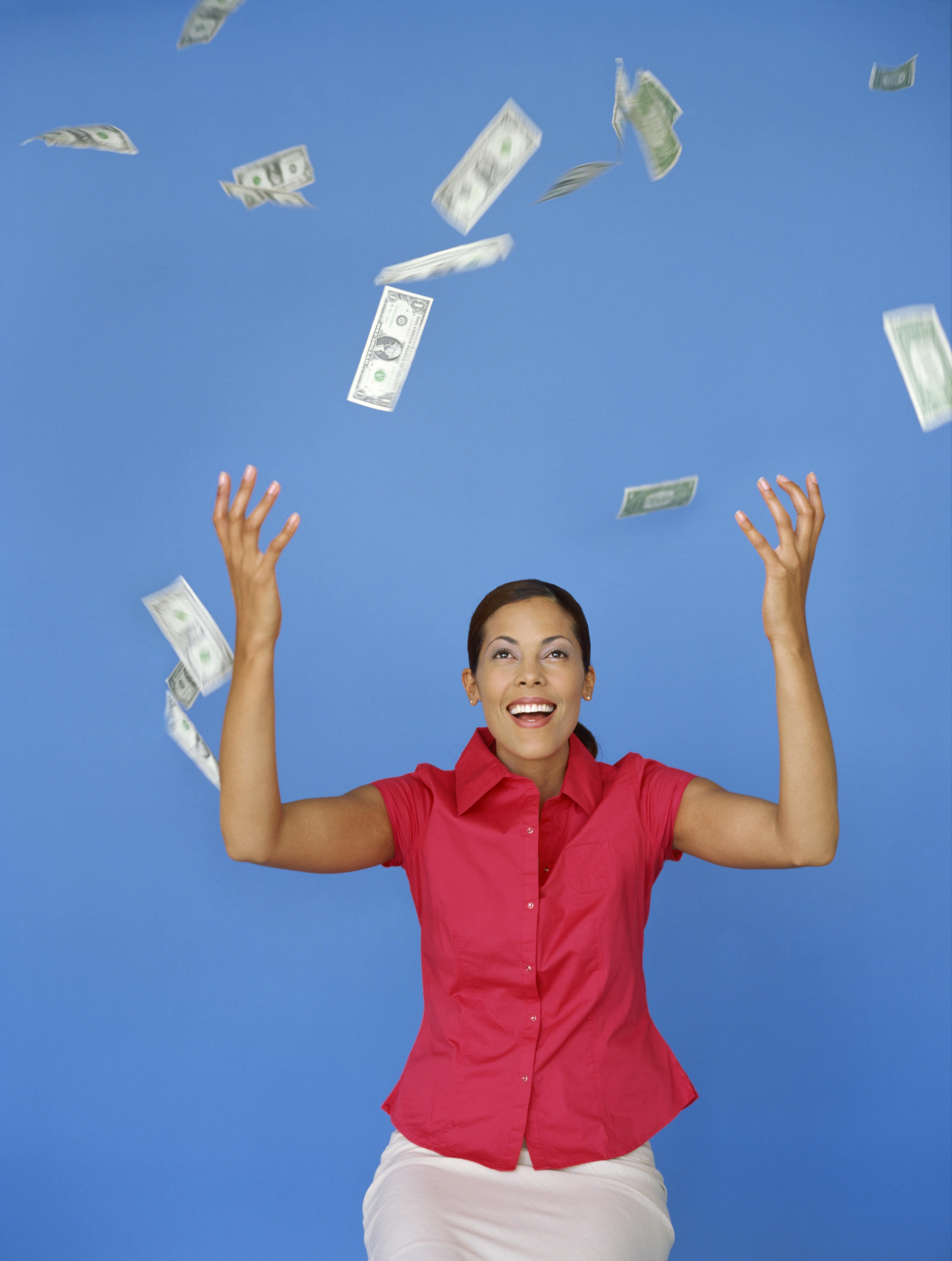 money falling around a businesswoman