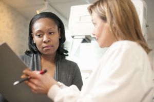 Nurse with patient signing consent for mammogram