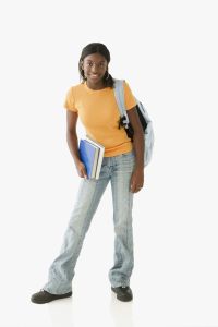 Student posing for the camera with a backpack