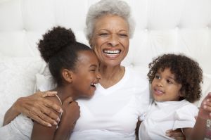 Older woman and grandchildren hugging