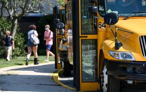 Buses wait outside Long Island high school at the end of first day of school in 2020