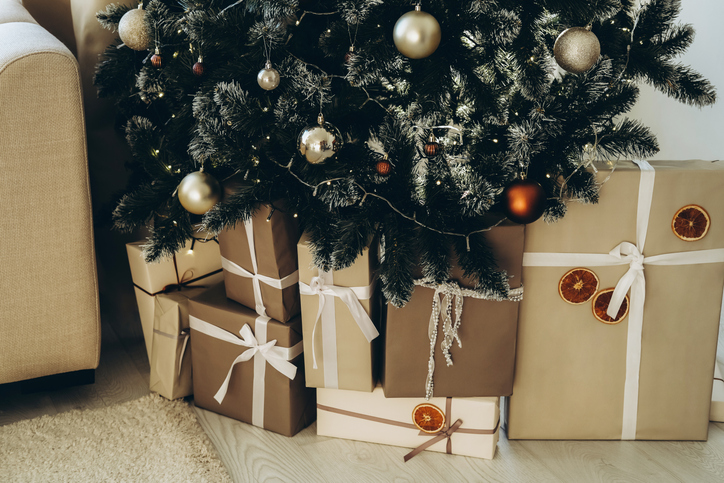 Gift boxes under new year tree indoors.